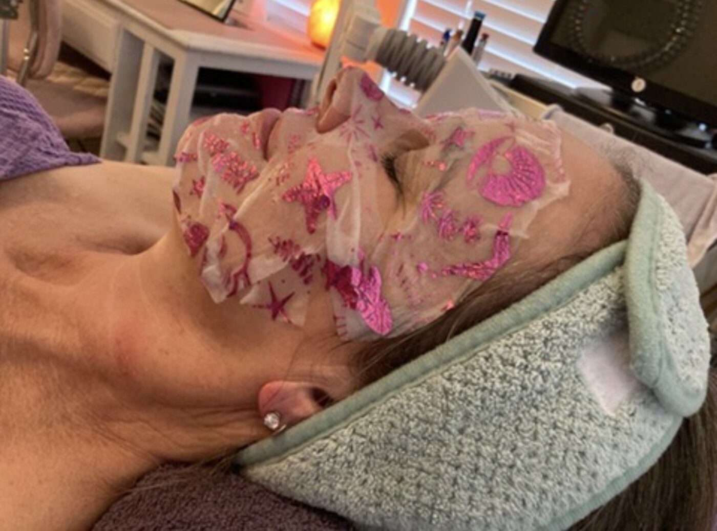 Client wearing a glitter facial mask during treatment at Opal Aesthetics & Wellness