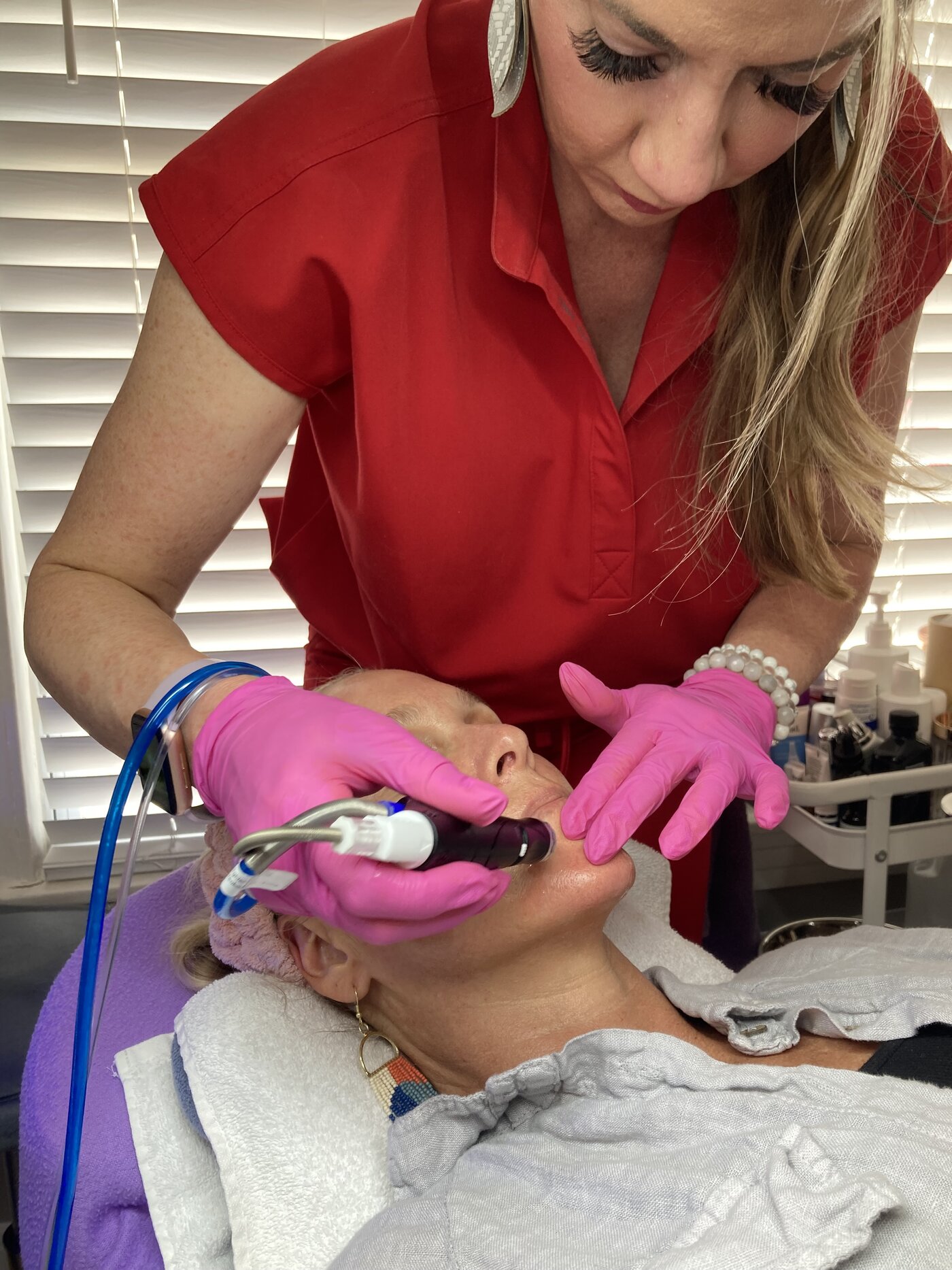 Priscilla performing a close-up HydraFacial treatment at Opal Aesthetics & Wellness