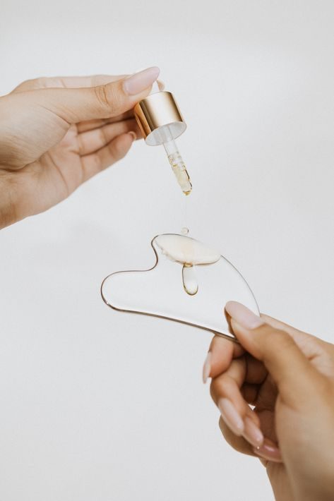 Skincare ritual with serum and gua sha tool, part of the take-home routines recommended at Opal Aesthetics & Wellness